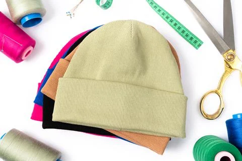 Top view of a stack of insulated stylish beanie hats in different colours Stock Photos