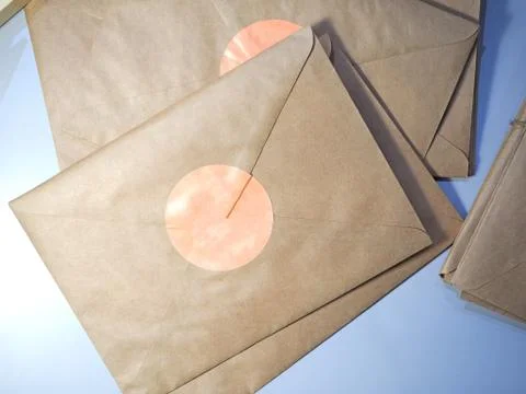 Top view of a Stack of letters in Kraft envelopes lying on the table tied wit Stock Photos