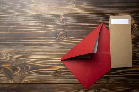 Top view of stack of two envelope and postcard on wooden background. The en.. 스톡 사진