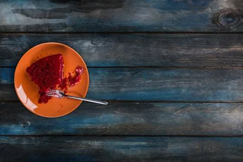 Top View. Start eating slice of delicious Red velvet cake on a ceramic plate Stock Photos