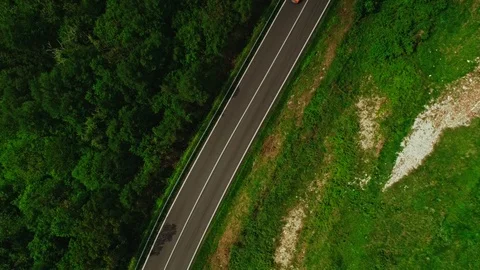 Top view static shot modern asphalt highway with moving cars surrounded by green Stock Footage 108806489