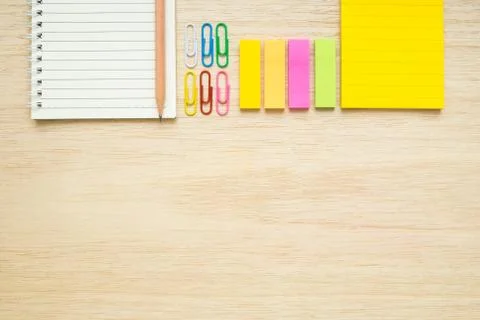 Top view of stationery items - notepad, notebook, sticky note, paper clips, p Stock Photos