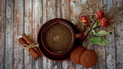 Top view of steaming hot coffee with cinnamon and cookies Stock Footage 334572724