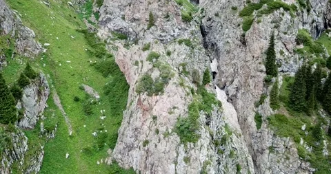 Top view of steep mountain cliffs and an ice cave. Video stock 139960410