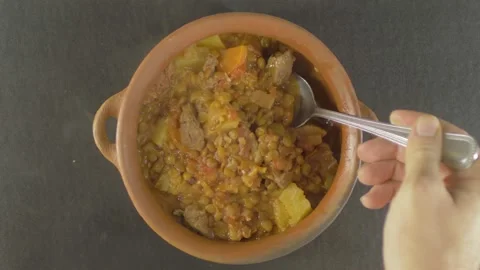 TOP VIEW Stew of Brown lentils Tradicional Spanish dish Lentejas in a clay pot Video stock 131066871