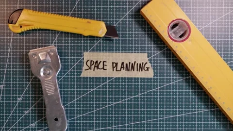 Top view of sticking SPACE PLANNING tape label near tools. Stock Footage 337816304
