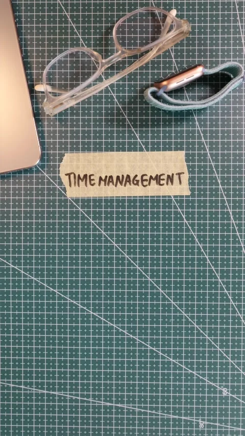 Top view of sticking TIME MANAGEMENT tape sticker near smartwatch and phone Stock Footage 338183573