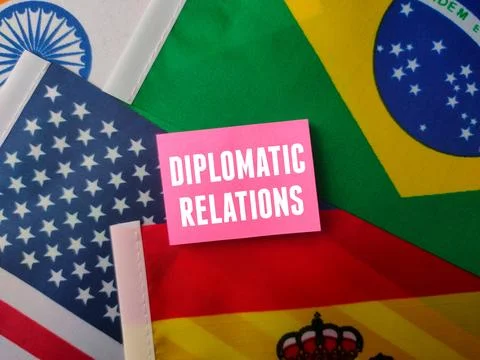 Top view sticky note with the word Diplomatic Relations on a world flag bac.. Stock Photos