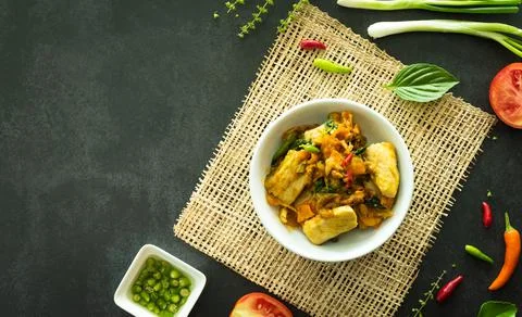 Top view of stir fried basil with fish served in a bowl on dark stone backgro Stock Photos