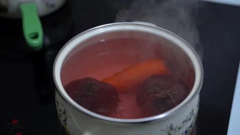 TOP VIEW: Stirring beetroot, carrot for the soup Stock Footage 154627781