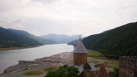Top view of stone temple, wide river, and mountains with green vegetation. Stock Footage 106029516