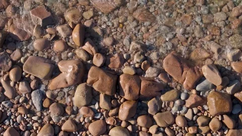 Top View Of A Stony Beach With Calm Waves At Sunset. Aerial Ascending Shot Vidéo 271537295