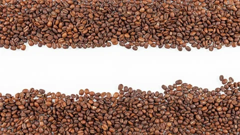 Top view of stop motion roasted coffee beans arranged in letters Stock Footage 136932222