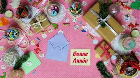 Top view stop motion on the theme of holiday with text Bonne Annee emerging from Stock Footage 94150385