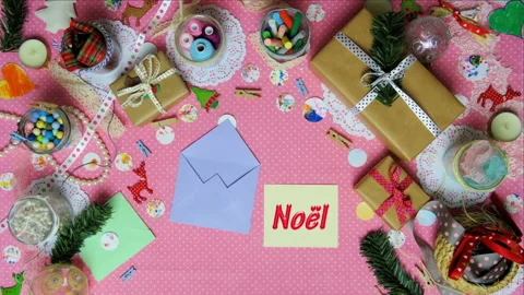 Top view stop motion on the theme of holiday with text Noel emerging from partic Stock Footage 94150467