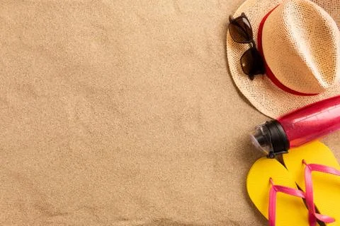 Top view straw hat with copy space. Traveler accessories on sand. Travel vaca Stock Photos