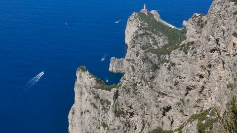 Top view of a stunning path hill with colorful trees clear sea water lighthouse Stock Footage 112345152