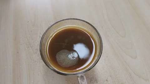 Top View of Sugar Pouring into a Glass Coffee Mug Stock Footage 341933290