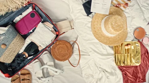 Top View of Suitcase and Clothes on Bed Stock Footage 143907013