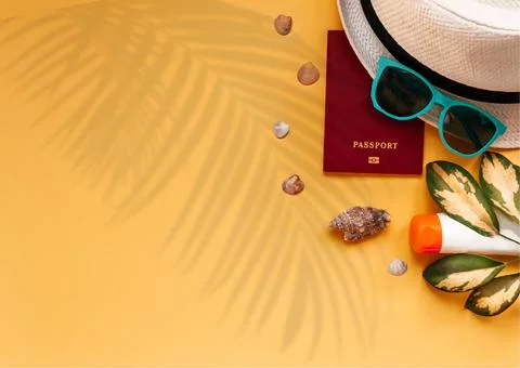 Top view of summer beach accessories and passport on orange background Foto stock