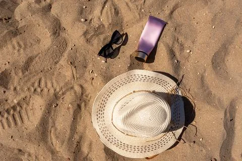 Top view of summer beach essentials layout featuring a woven straw hat black  Stock Photos
