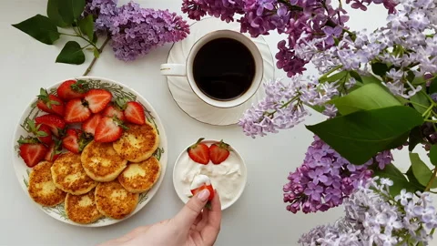 Top view of summer breakfast with syrniki and strawberries. Stock Footage 338194475