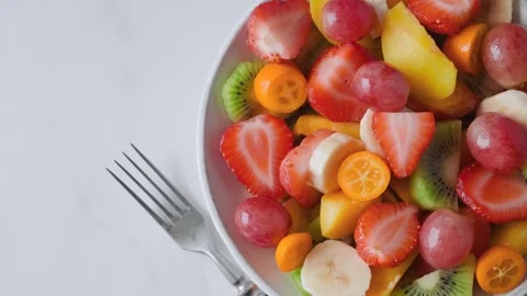 Top view of of summer fresh fruit salad in a bowl. Healthy food for breakfast Stock-Footage 284928255