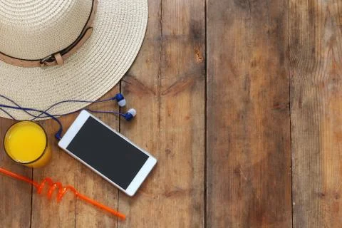 Top view of summer hat, fruit cocktail and cell phone Stock Photos