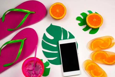 Top view summer set with cell phone,flip flops, cold cocktail and orange ice  Stock Photos