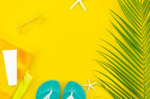 Top view summer trip flat lay frame with women's things on yellow background Stock Photos