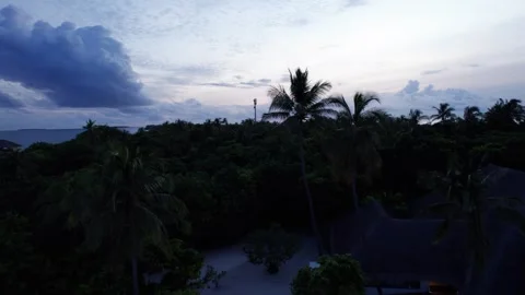 Top view of the sunset over an island in the ocean 動画素材 295353653