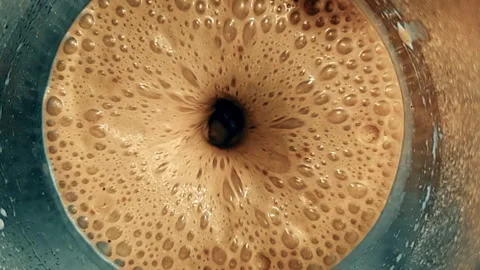 Top of view of super slow motion shot of fresh cream brown coffe vortex Video stock 254777080