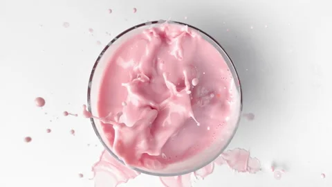 Top view super slow-motion of strawberry milkshake or yogurt and falling berries Stock Footage 280240765