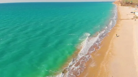 Top view of a superb lonely and deserted beach on the shores of the azure sea. Stock Footage 106946225