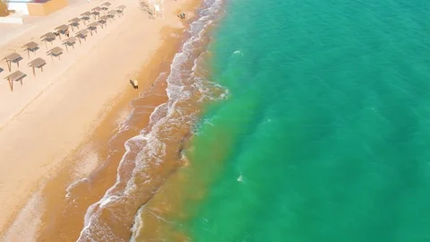 Top view of a superb lonely and deserted beach on the shores of the azure sea. Stock Footage 106946711