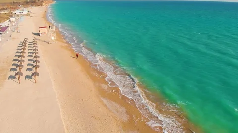 Top view of a superb lonely and deserted beach on the shores of the azure sea. Stock Footage 106947489