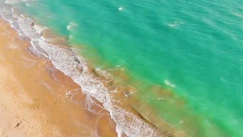 Top view of a superb lonely and deserted beach on the shores of the azure sea. Stock Footage 106947617
