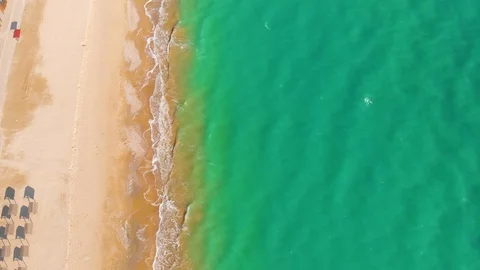 Top view of a superb lonely and deserted beach on the shores of the azure sea. Stock Footage 106947734
