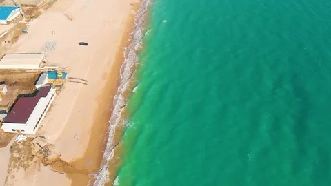 Top view of a superb lonely and deserted beach on the shores of the azure sea. Stock Footage 106947809