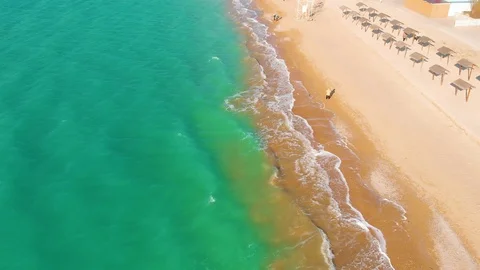 Top view of a superb lonely and deserted beach on the shores of the azure sea. Stock Footage 106948527