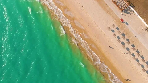 Top view of a superb lonely and deserted beach on the shores of the azure sea. Stock Footage 106948674