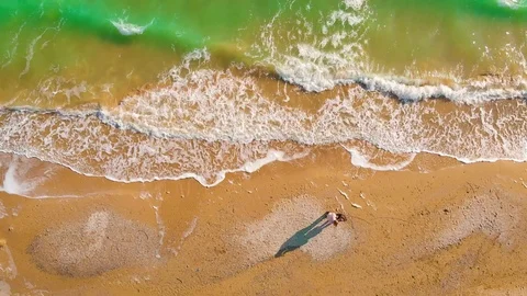 Top view of a superb lonely and deserted beach on the shores of the azure sea. Stock Footage 106949604