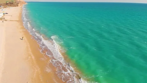 Top view of a superb lonely and deserted beach on the shores of the azure sea. Stock Footage 106949819