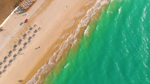 Top view of a superb lonely and deserted beach on the shores of the azure sea. Stock Footage 106950400