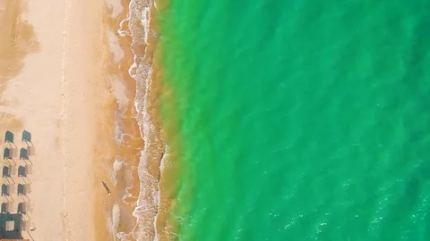 Top view of a superb lonely and deserted beach on the shores of the azure sea. Stock Footage 106950669