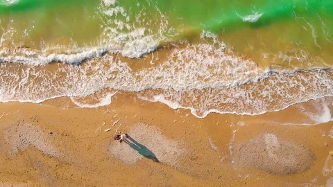 Top view of a superb lonely and deserted beach on the shores of the azure sea. Stock Footage 106951659