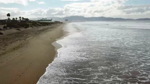 Top view of surf breaking on abeach with dunes Video stock 147696372