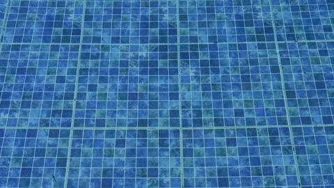 Top view of surface of the clear water and blue tile pattern in swimming pool. Stock Footage 309295980