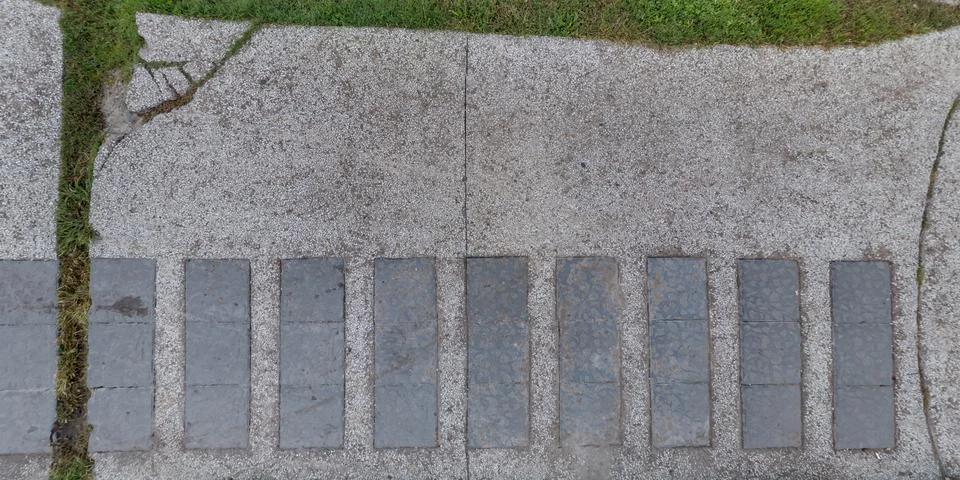 Top view of surface of pedestrian path with paving slabs with the border of l Stock Photos