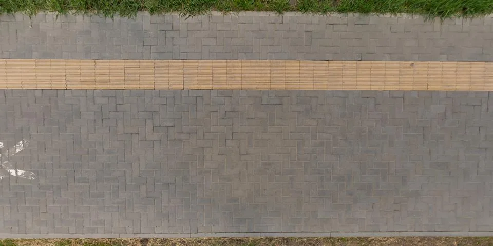 Top view of surface of pedestrian path with paving slabs with the border of l Stockfoto's